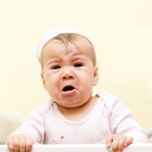 Portrait of crying baby girl.